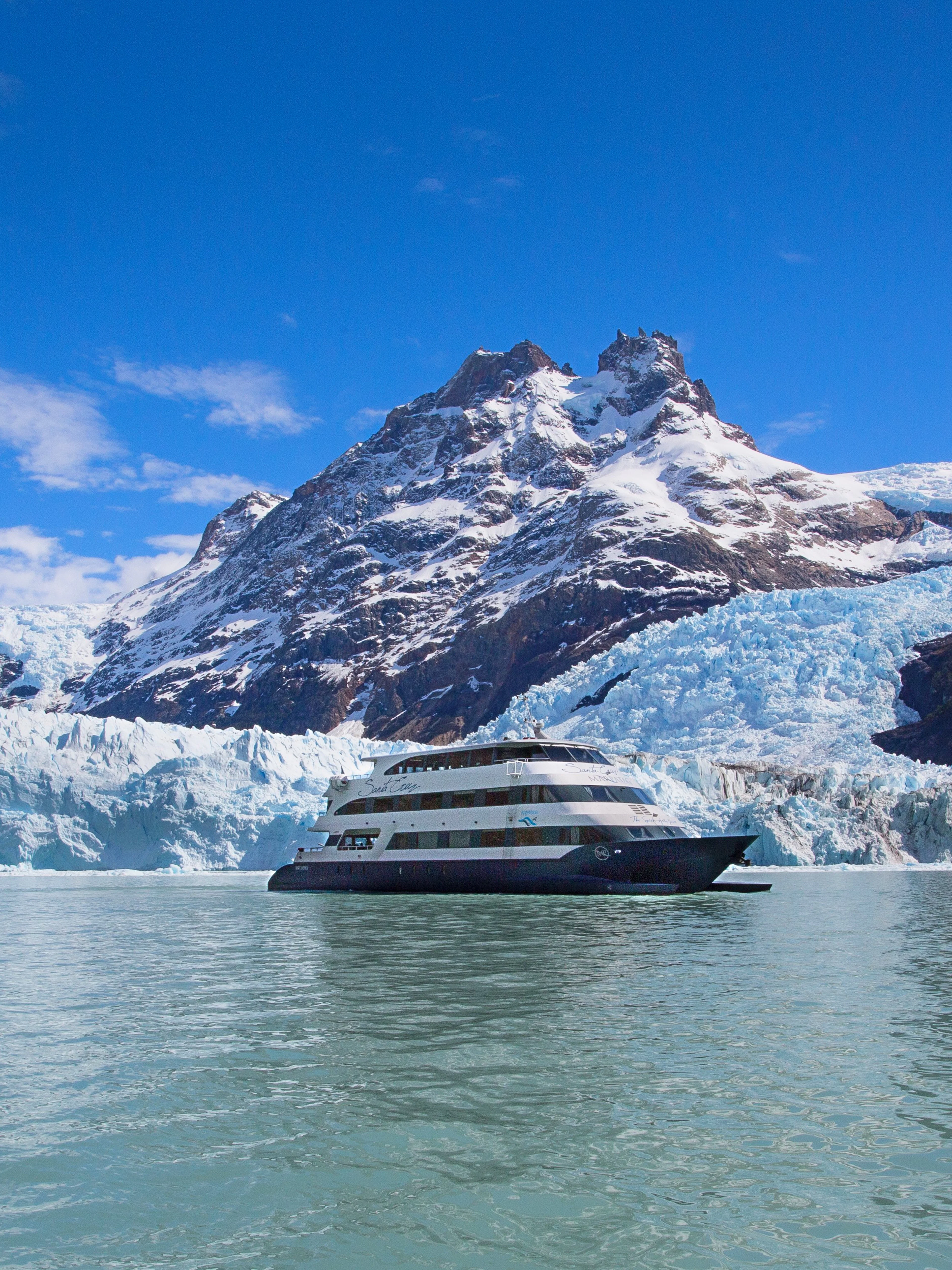 Boat cruising near glacier during Spirit of the Glaciers tour in Patagonia.