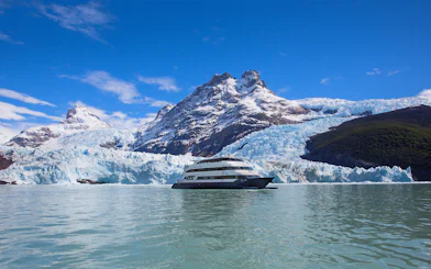 Boat cruising near glacier during Spirit of the Glaciers tour in Patagonia.