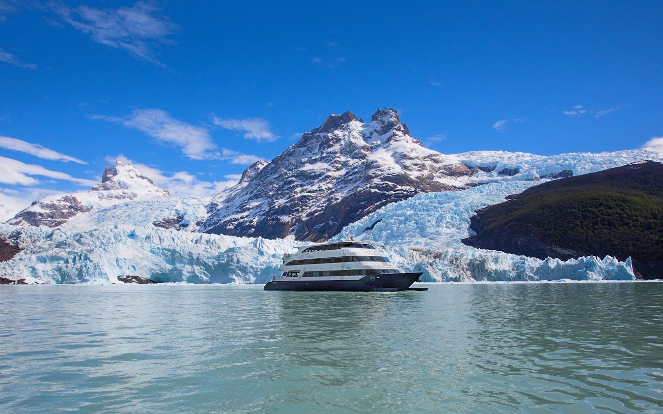 Boat cruising near glacier during Spirit of the Glaciers tour in Patagonia.