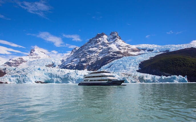 Boat cruising near glacier during Spirit of the Glaciers tour in Patagonia.