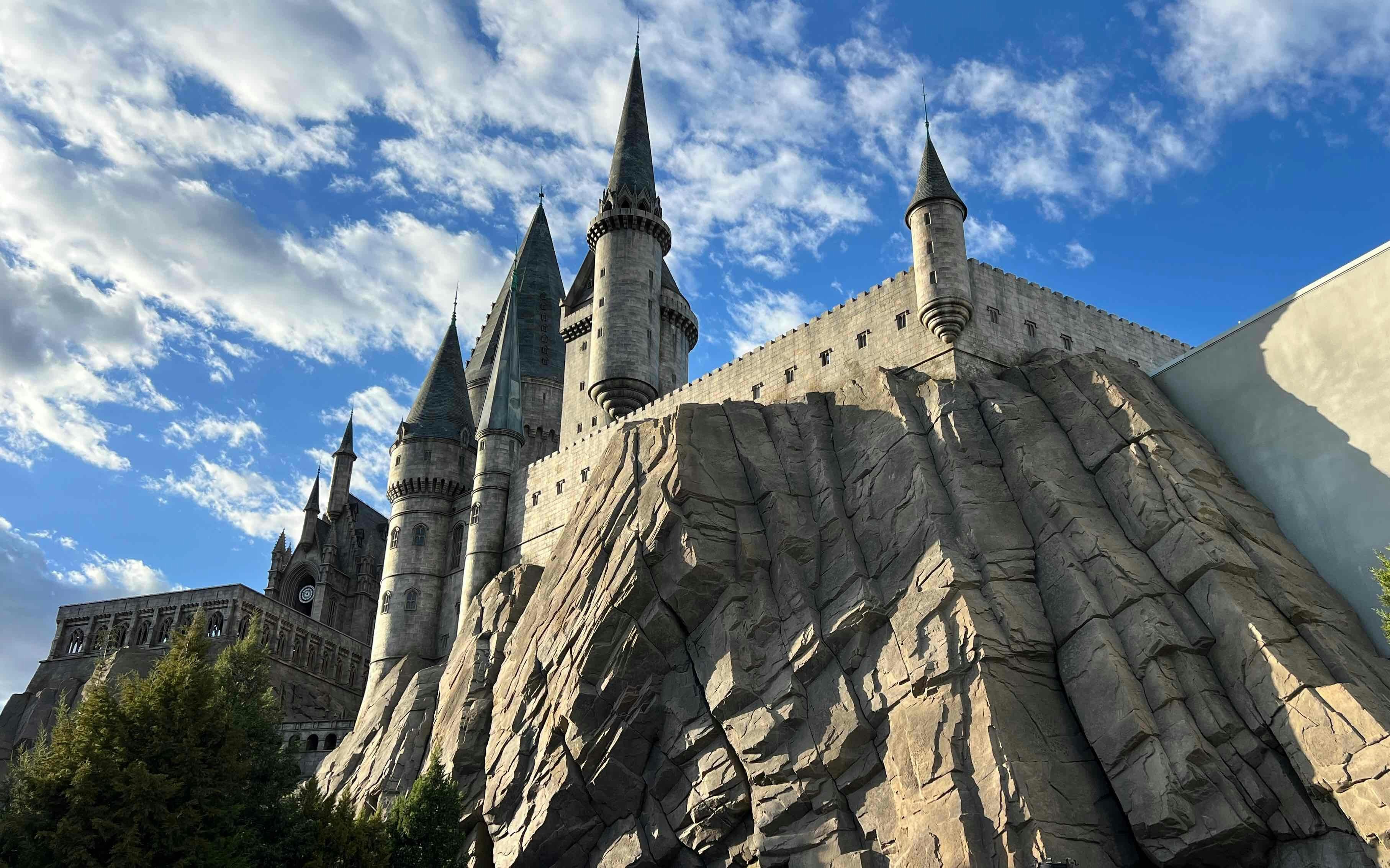 Hogwarts castle replica at Universal Studios Beijing with rocky facade and spires.
