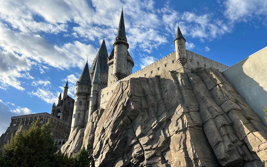 Hogwarts castle replica at Universal Studios Beijing with rocky facade and spires.