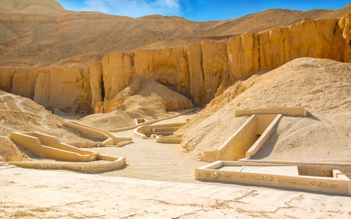 Valley of the Queens tomb entrances in Luxor, Egypt, surrounded by desert cliffs.