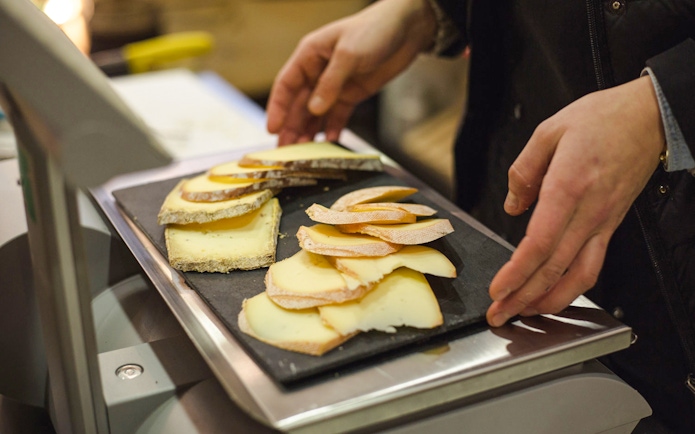 Cheese selection on tray at Paroles de Fromagers, Paris, France.