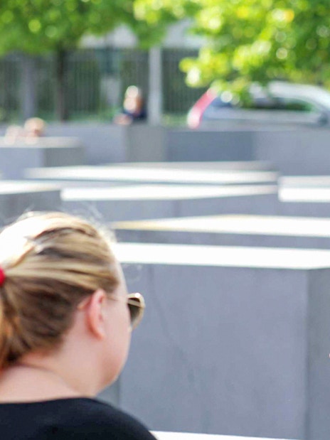 Guide explaining history during Berlin World War II walking tour.
