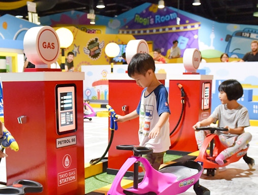 Children playing at Tayo Station gas station-themed ride.