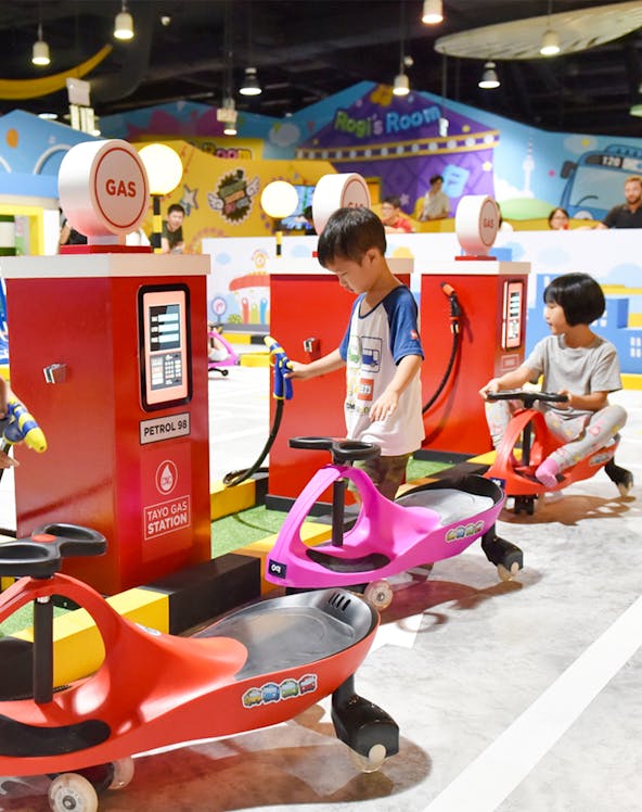 Children playing at Tayo Station gas station-themed ride.
