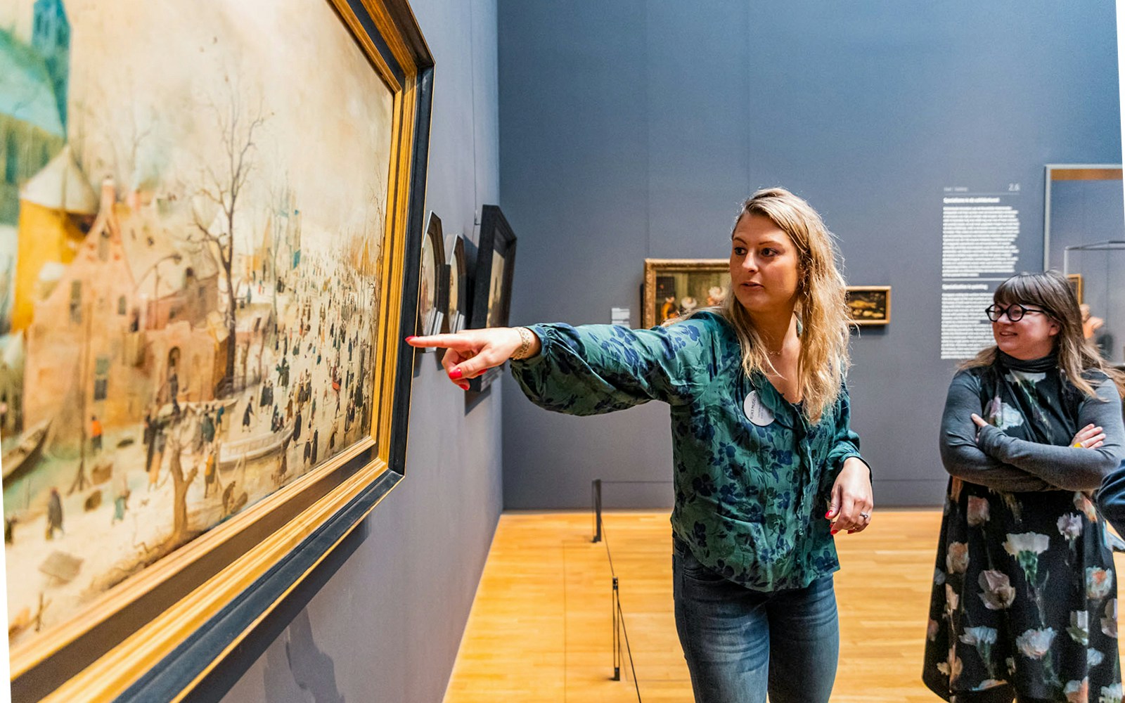 Visitor pointing at a painting in Rijksmuseum, Amsterdam.