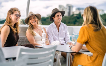 Group enjoying drinks on a Darwin Harbour lunch cruise.