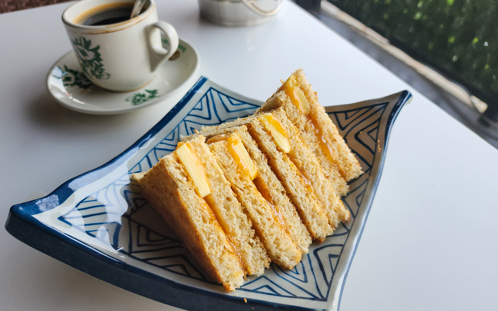 Traditional, oriental and vintage Kopitiam breakfast style Kaya toasts and black coffee