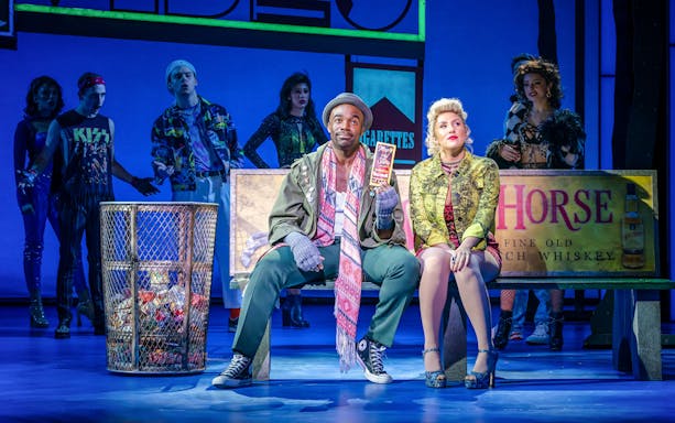 Actors performing a scene from Pretty Woman The Musical on stage.