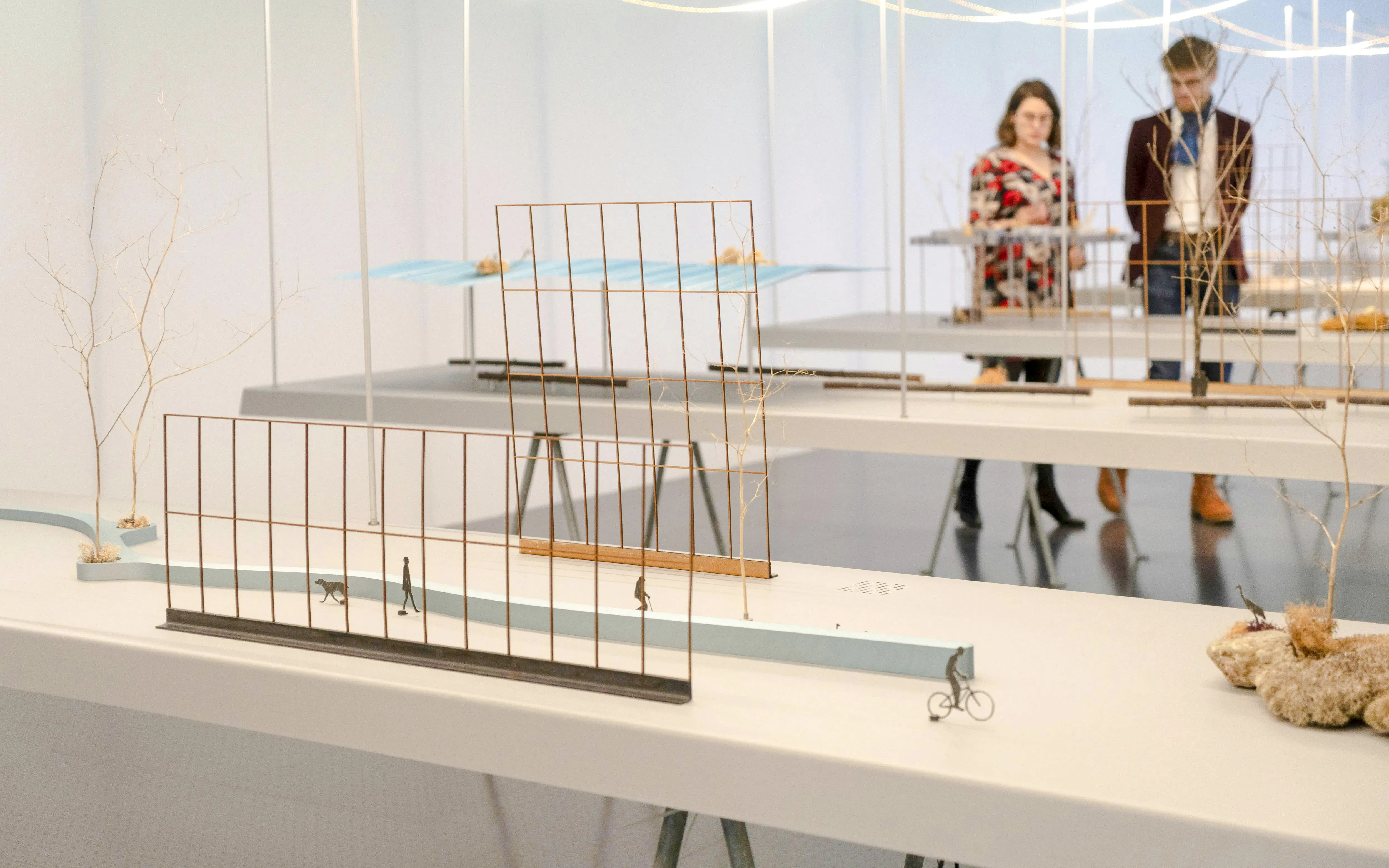 Centre Pompidou-Metz exhibit with architectural models and visitors observing.