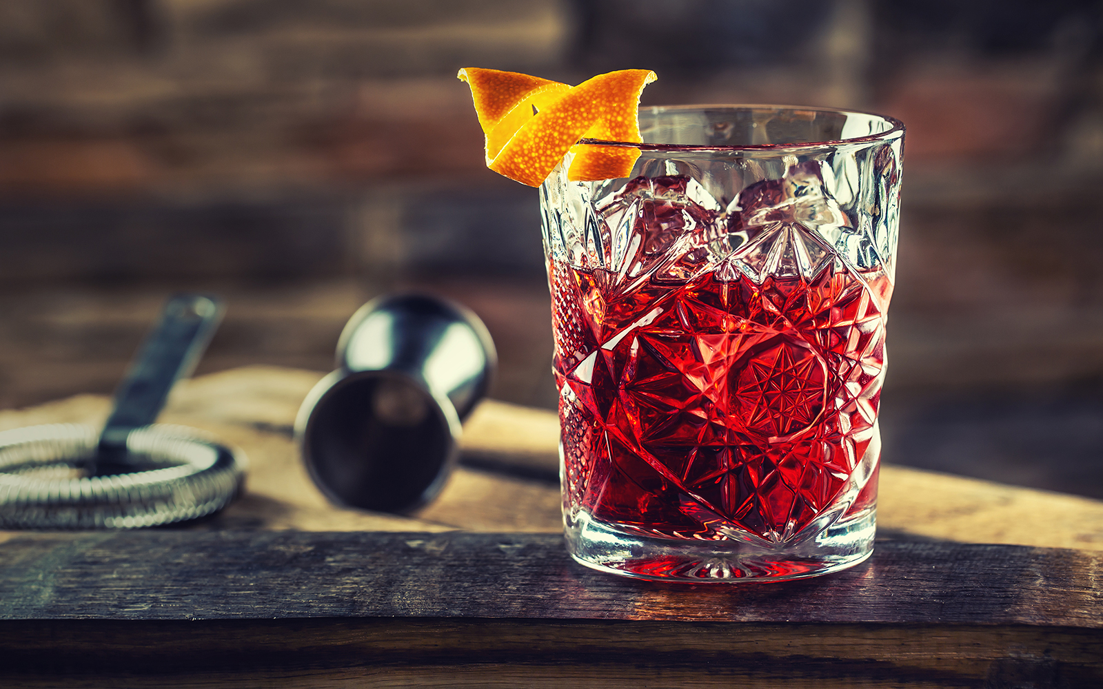 Vermouth cocktail with orange twist in a crystal glass