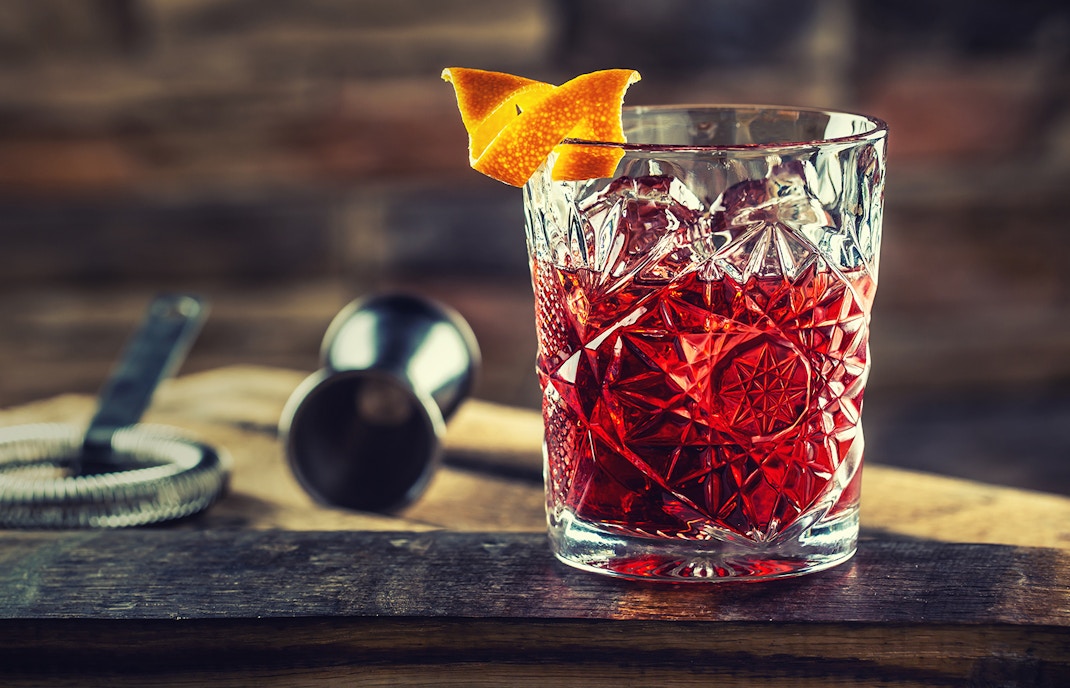 Vermouth cocktail with orange twist in a crystal glass