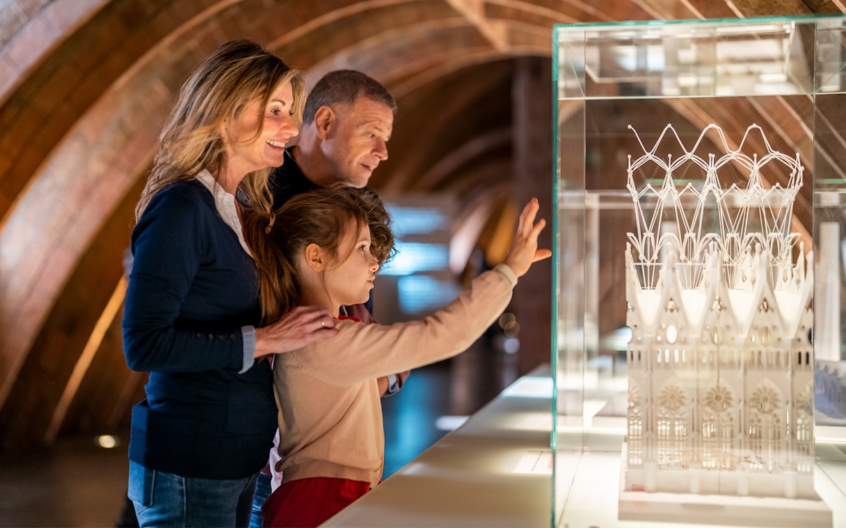 Visitors observing architectural model at La Pedrera-Casa Milà, Barcelona.