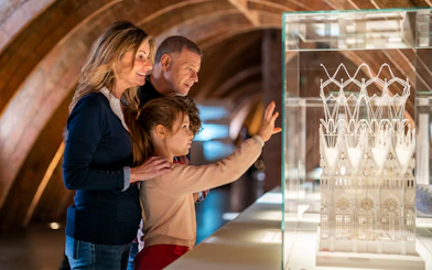 Visitors observing architectural model at La Pedrera-Casa Milà, Barcelona.