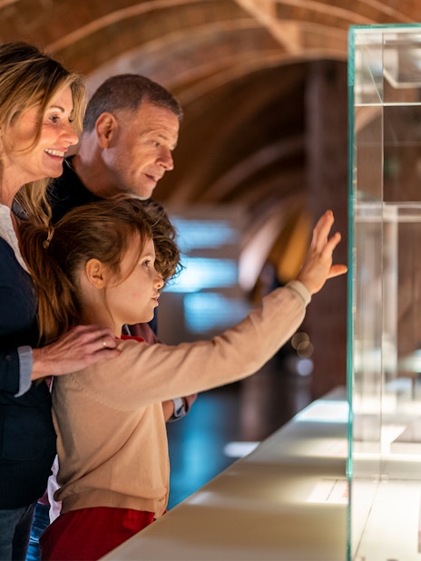 Visitors observing architectural model at La Pedrera-Casa Milà, Barcelona.