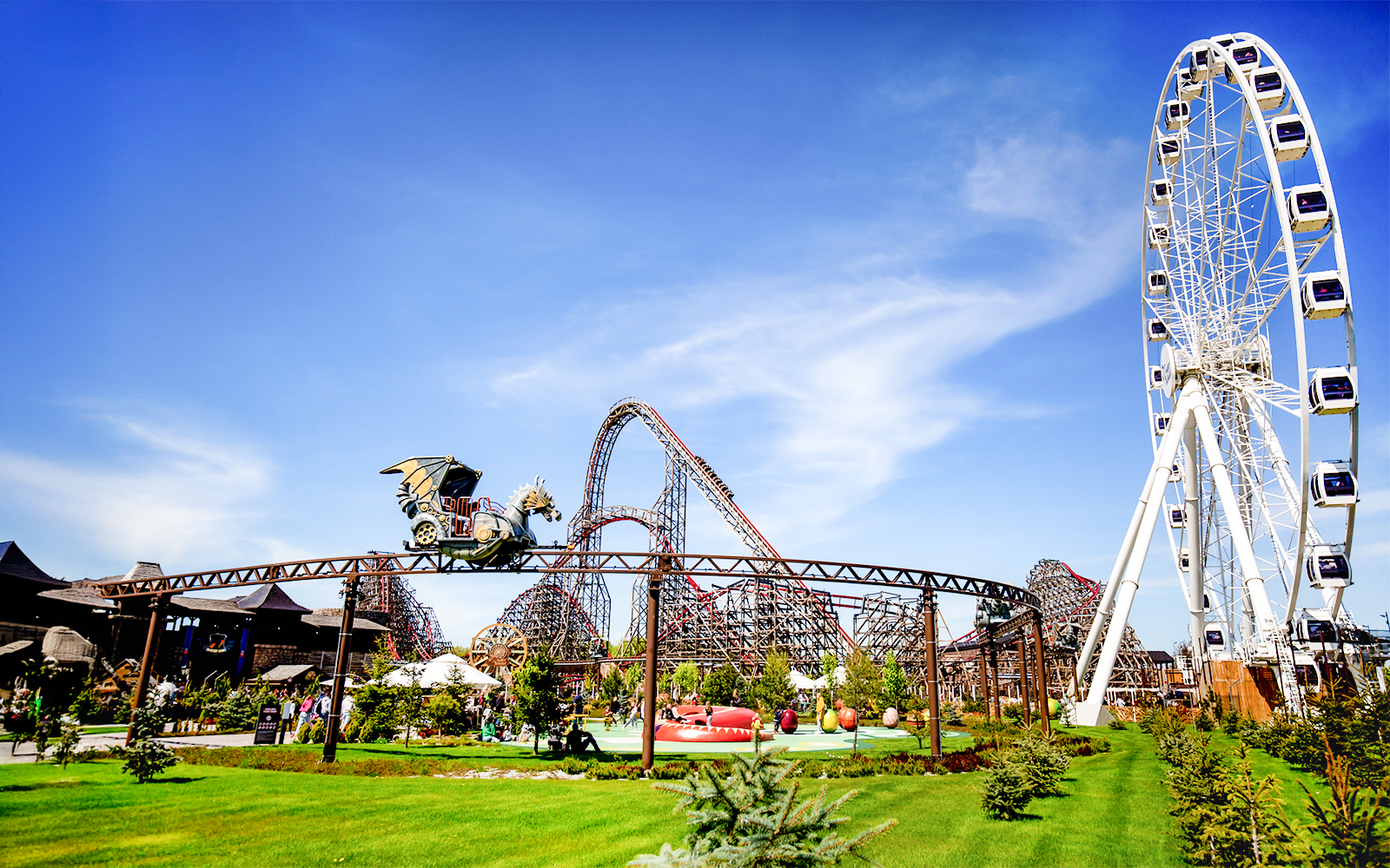 Rollercoaster and Ferris wheel at Energylandia Theme Park, Zator, near Krakow, Poland.