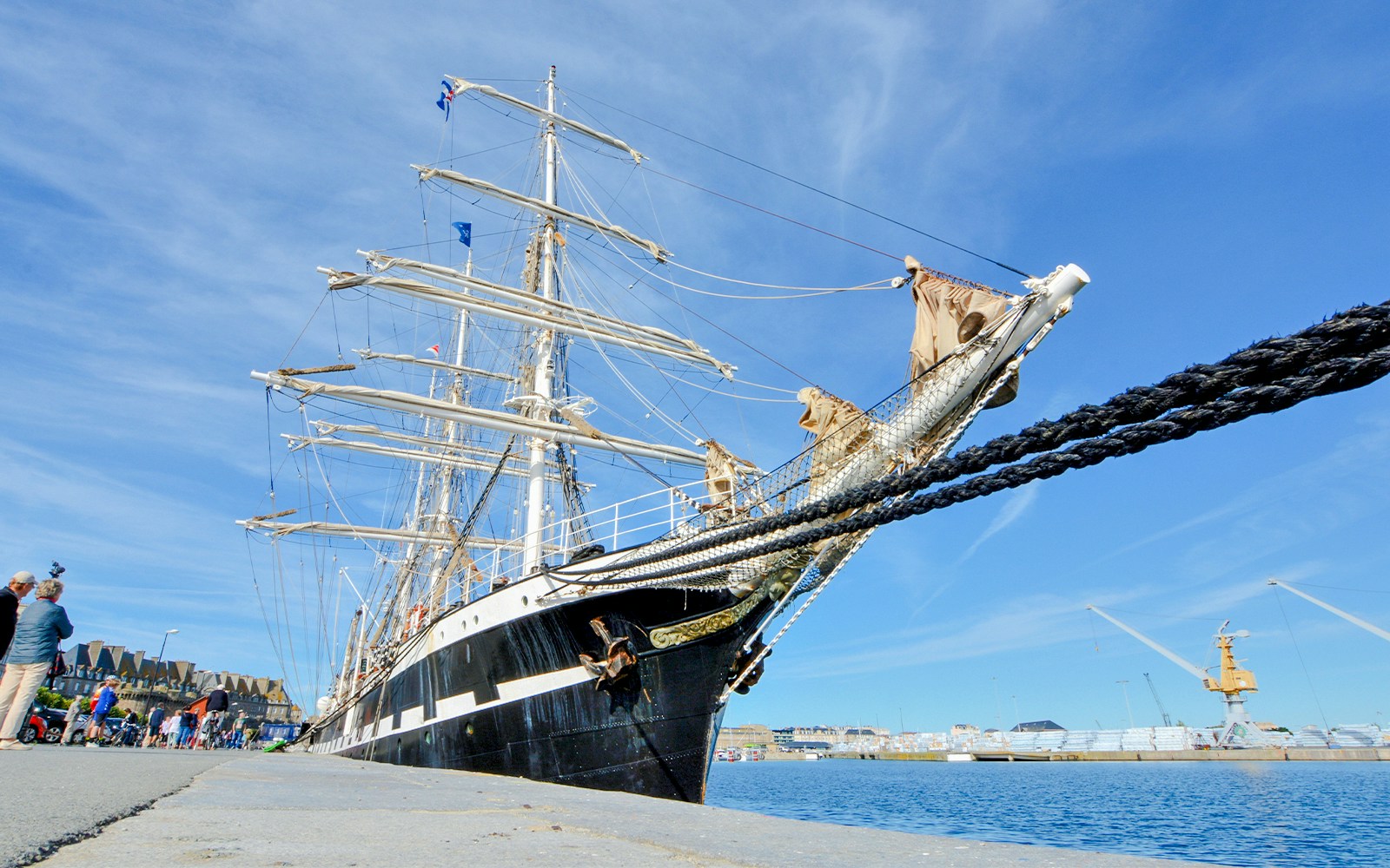 Belem ship docked in Lisbon, Portugal, showcasing its tall masts and intricate rigging.