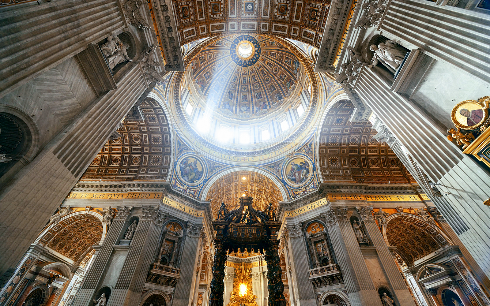St. Peter's Basilica interior with ornate ceiling and grand columns in Vatican City.