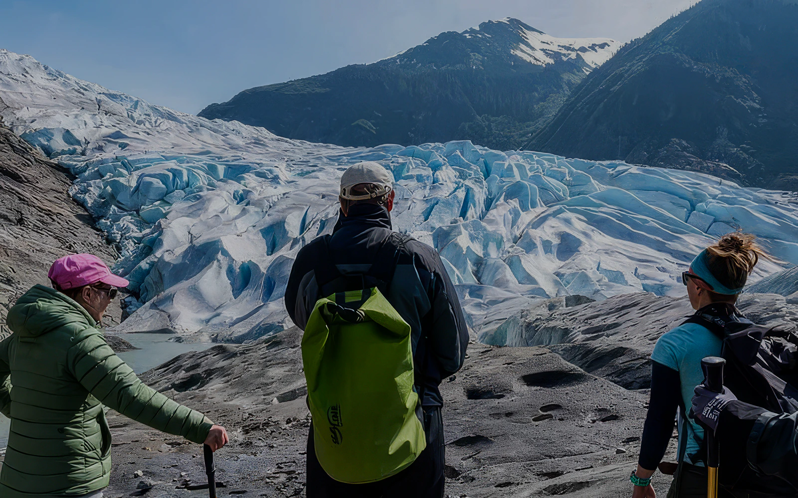 Hikers viewing Mendenhall Glacier in Alaska during a canoe paddle and hike tour.