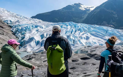 Hikers viewing Mendenhall Glacier in Alaska during a canoe paddle and hike tour.