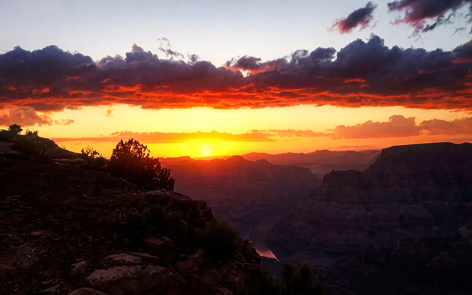 Grand Canyon West sunset with vibrant sky and canyon silhouette.