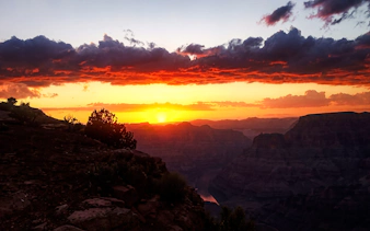 Grand Canyon West sunset with vibrant sky and canyon silhouette.