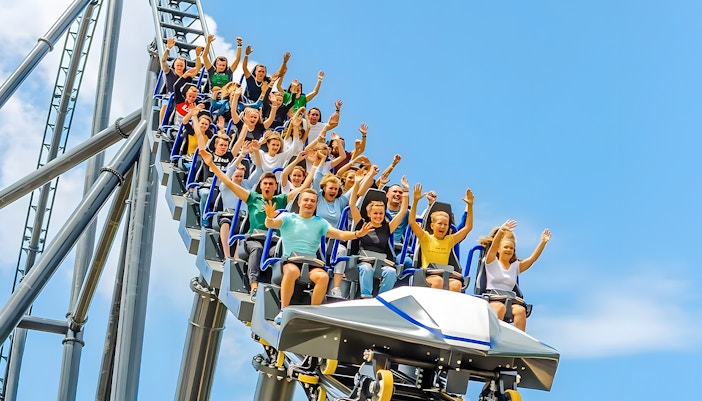 Roller coaster Pepsi Hyperion at Energylandia Extreme Zone, Poland, with steep drop and thrill-seekers.
