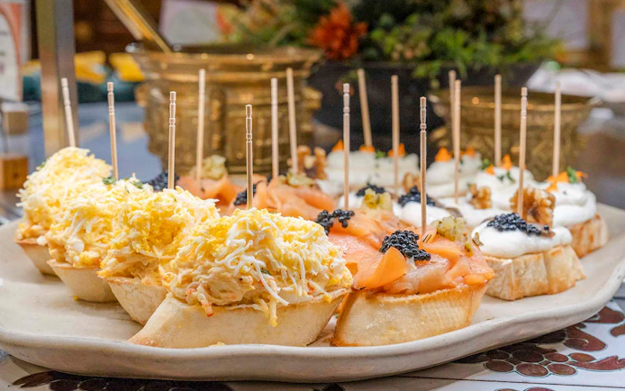 Tapas selection with cheese, salmon, and caviar at Tablao Cordobes, Barcelona.