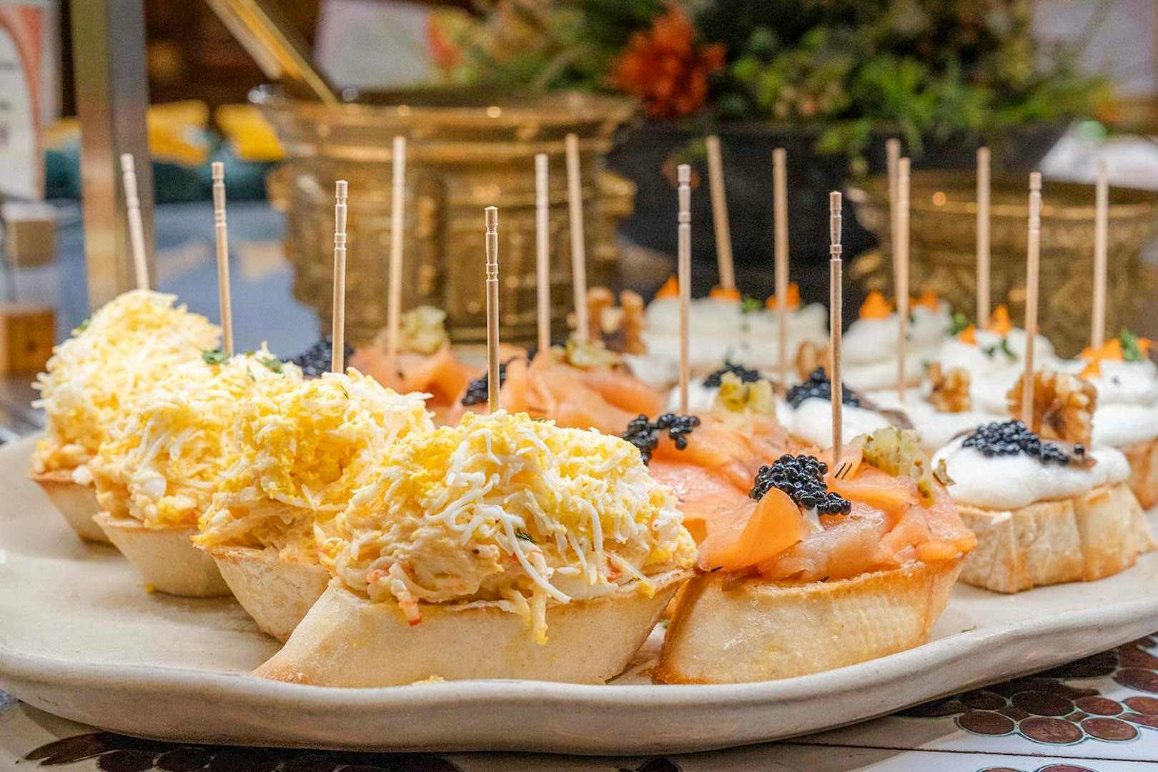 Tapas selection with cheese, salmon, and caviar at Tablao Cordobes, Barcelona.