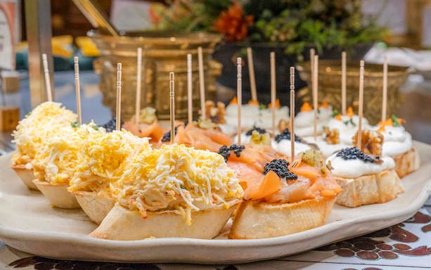 Tapas selection with cheese, salmon, and caviar at Tablao Cordobes, Barcelona.