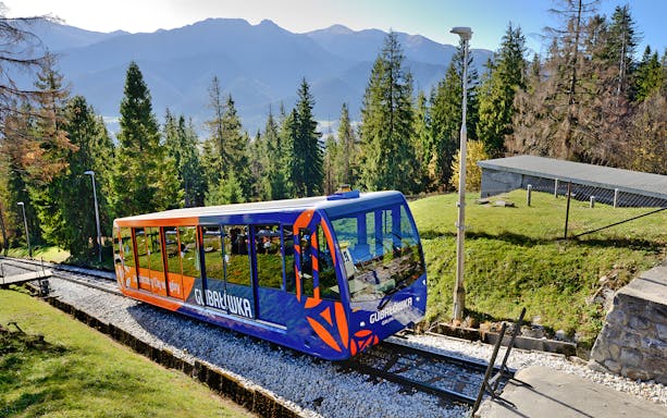 Cable car ascending Tatra Mountains with scenic view, Zakopane.
