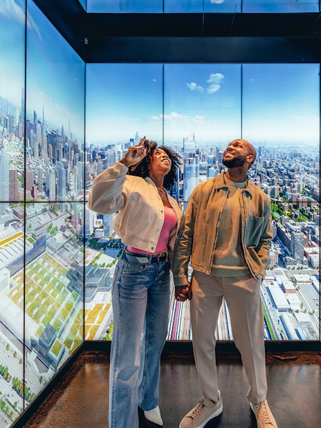Couple enjoying city skyline view at Edge observation deck in New York City.