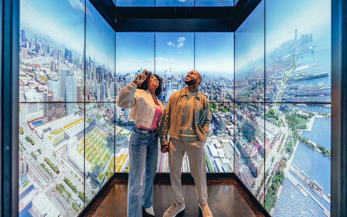 Couple enjoying city skyline view at Edge observation deck in New York City.