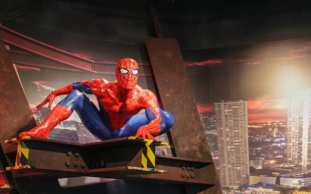 Spider-Man figure at Madame Tussauds Bangkok with cityscape backdrop.