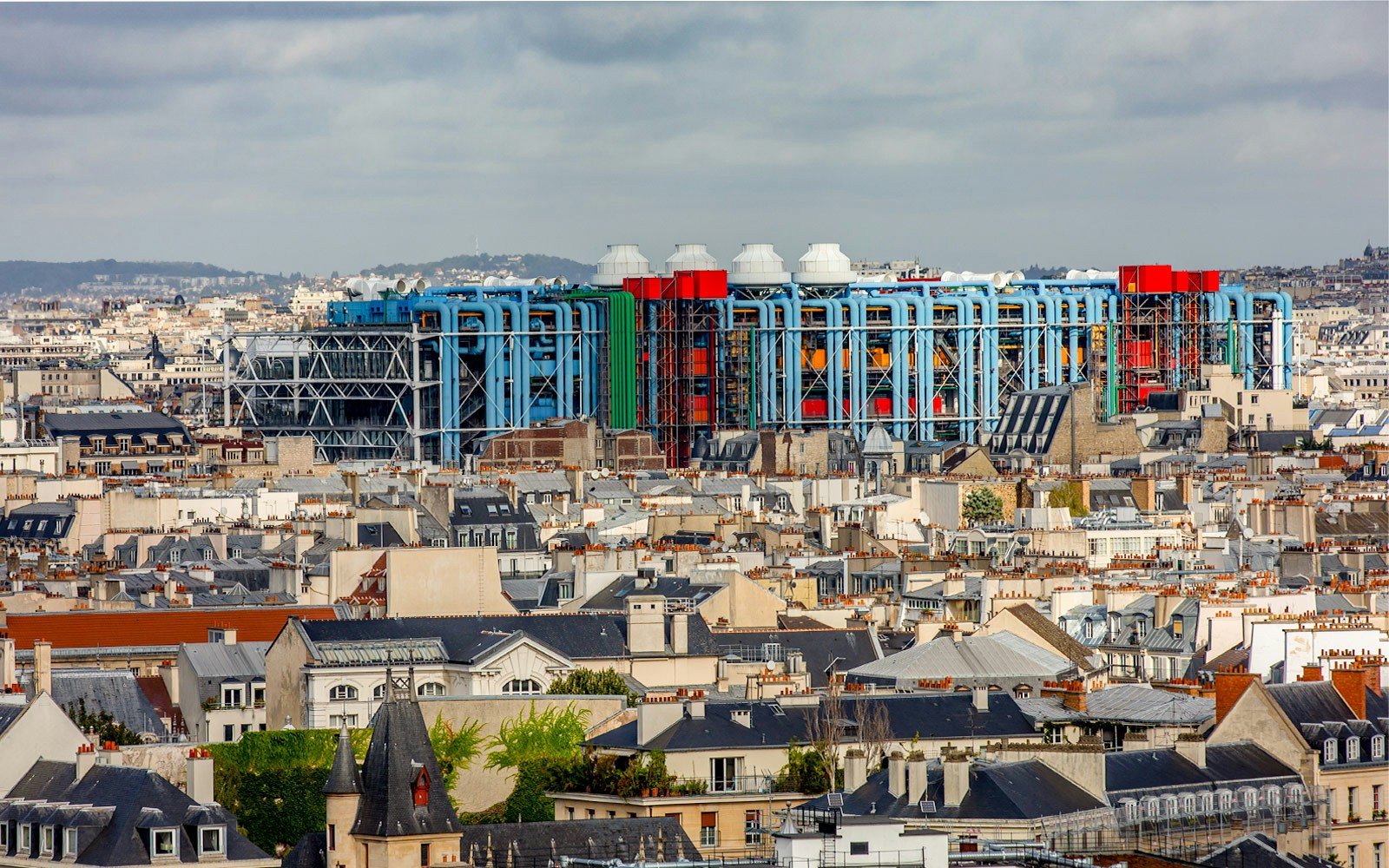 Centre Pompidou's colorful exterior above Paris rooftops.