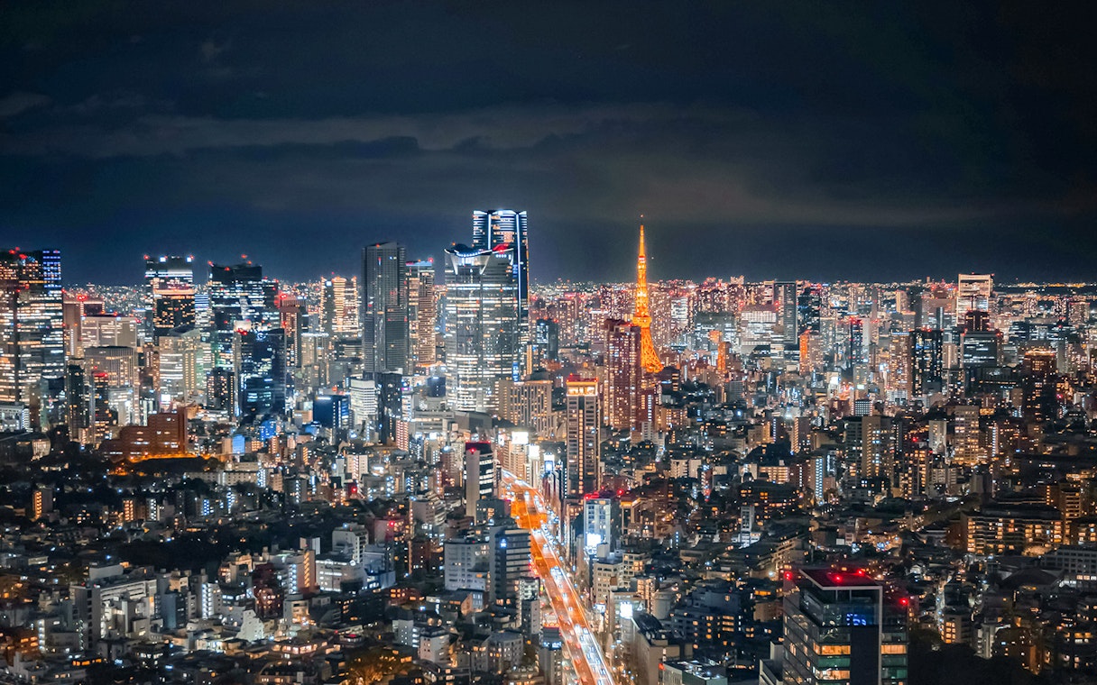 Tokyo skyline at night with Tokyo Tower from Shibuya Sky Deck.