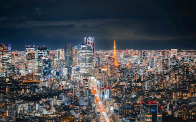 Tokyo skyline at night with Tokyo Tower from Shibuya Sky Deck.