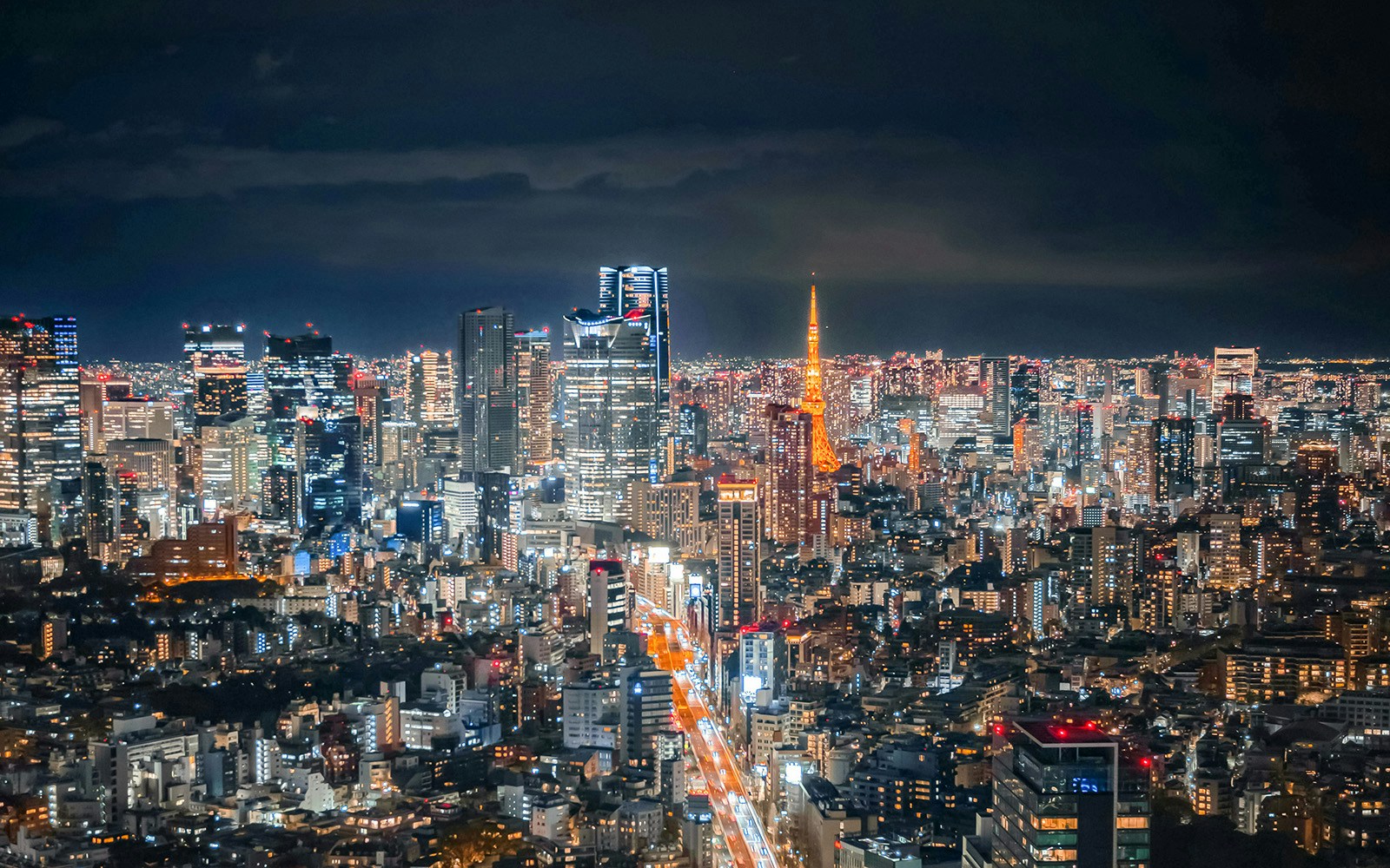 Tokyo skyline at night with Tokyo Tower from Shibuya Sky Deck.