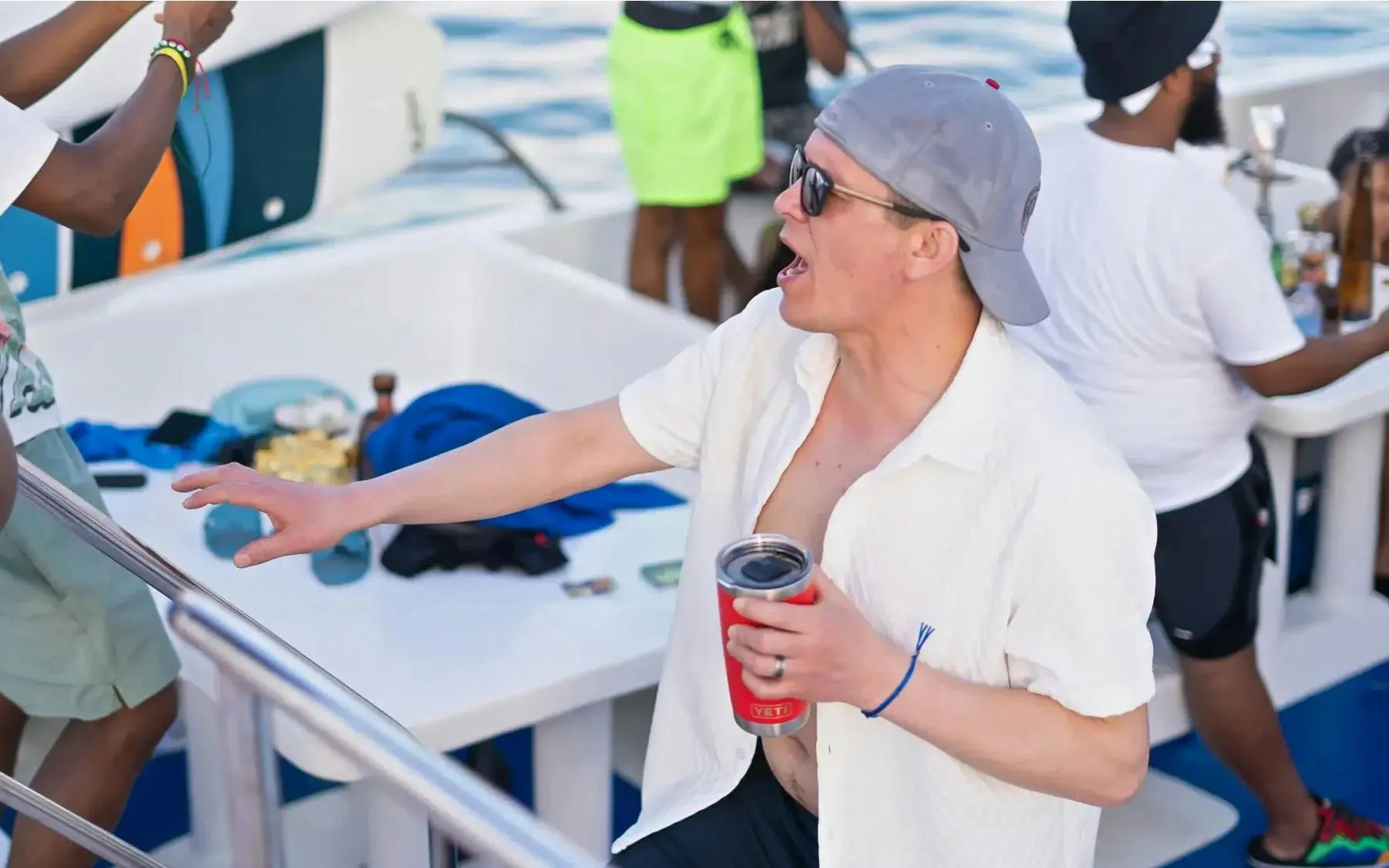 Partygoers enjoying a boat party with drinks in the Caribbean Sea near Punta Cana.
