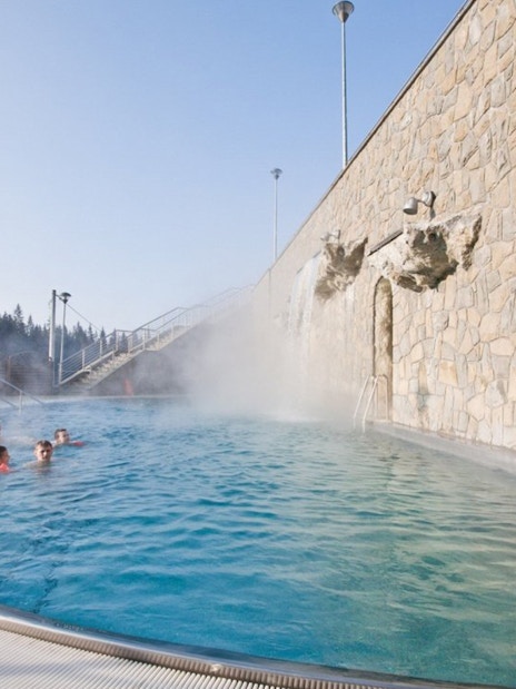 Outdoor hot bath pool with steam rising, part of Zakopane tour experience.