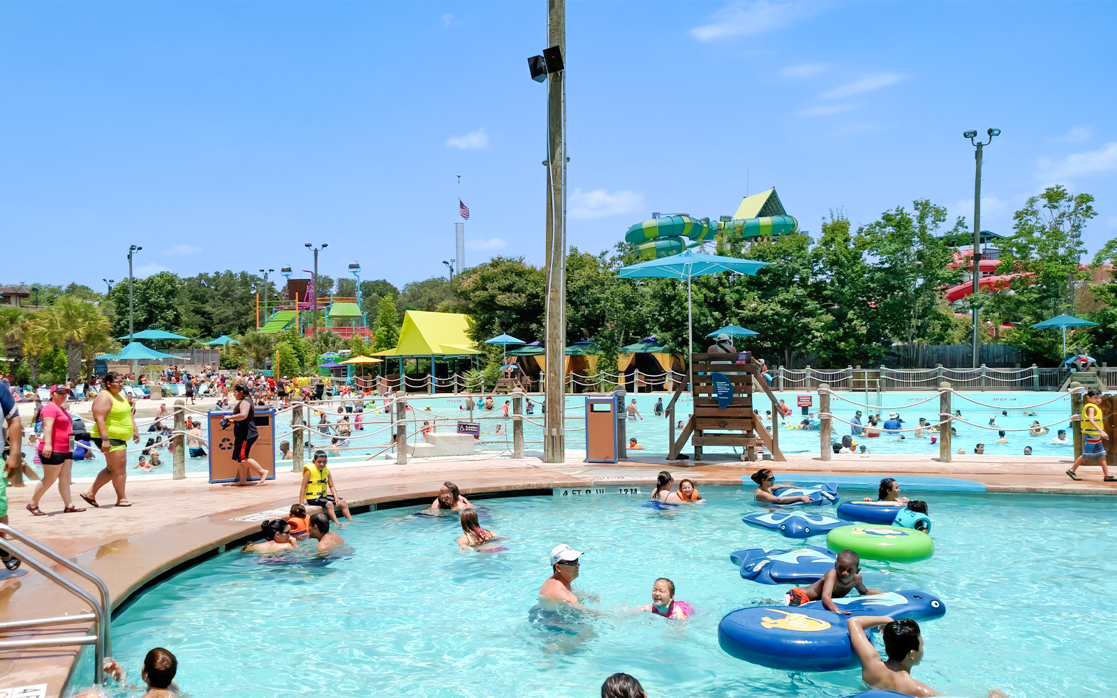 Guests enjoying the pool and water slides at Aquatica San Antonio, Texas.