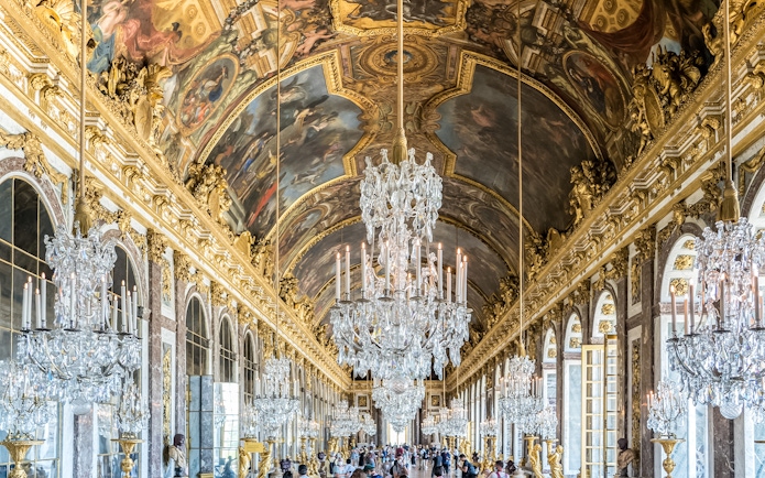 Hall of Mirrors, Versailles Palace, ornate chandeliers and ceiling frescoes, France.