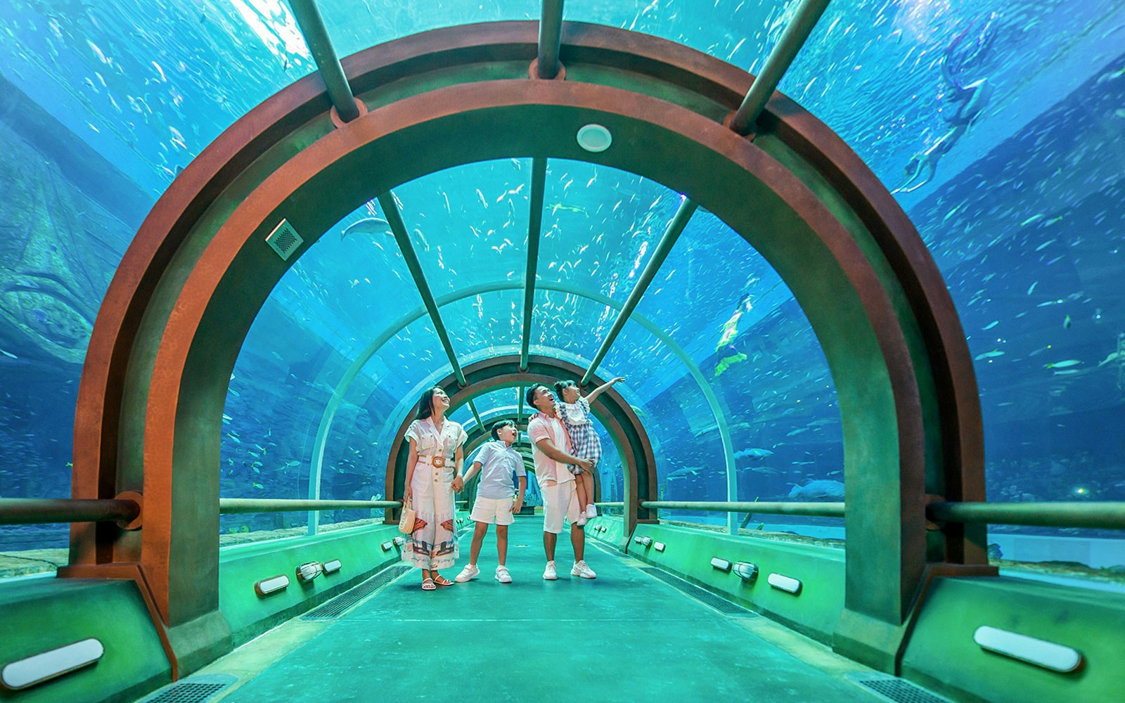 Family exploring underwater tunnel at Aquarium in VinWonders.