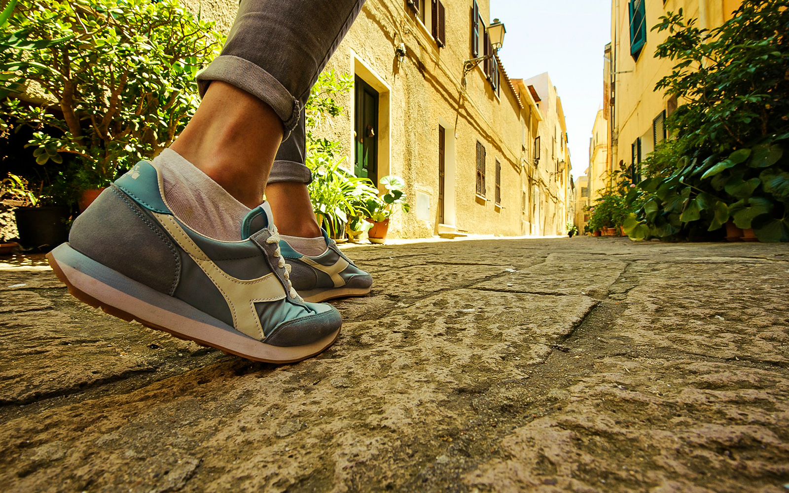 Walking through a narrow street in Castelsardo during a guided tour.