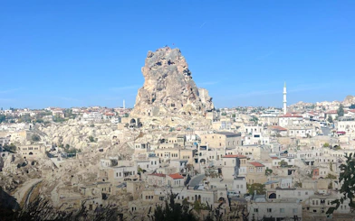 Ortahisar Fortress towering over Cappadocia's unique rock formations and historic townscape, Turkey.