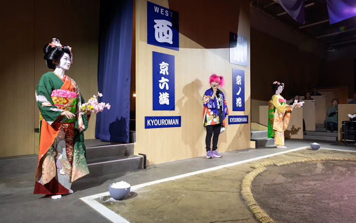 Kyoto sumo entertainment show with performers in traditional attire on stage.