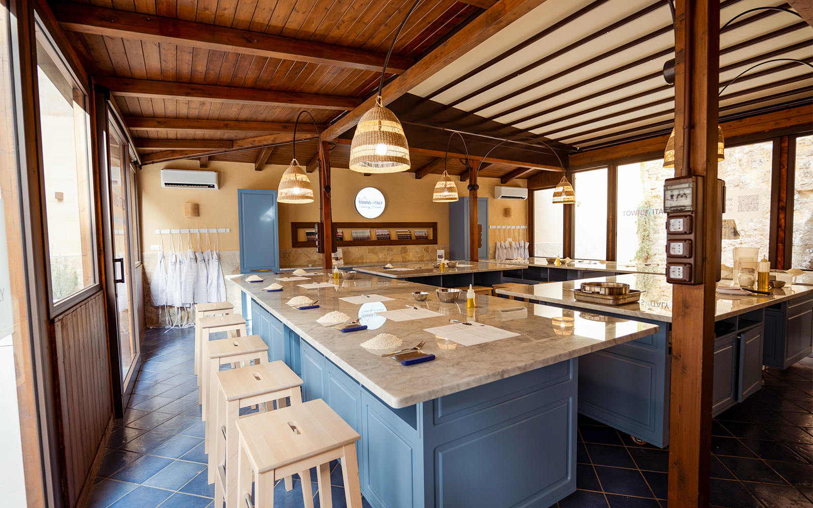 Cooking class setup with ingredients on marble counters in Palermo.