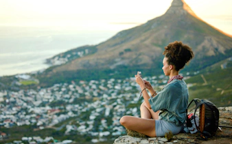 Woman photographing Cape Town view after hiking Lion's Head.